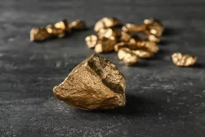 depositphotos 251812040 stock photo gold nuggets on dark background